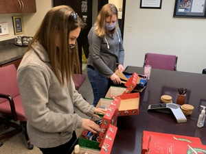 Beth and Amy pack Operation Christmas Child Shoeboxes